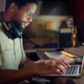 music producer working on laptop hero credit peopleimages getty 2000x1500 1068x801