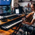 musician working on music in studio acoustic guitar credit kosamtu getty 2000x1500 1068x801